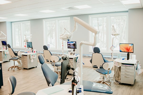 Bright orthodontic treatment room with multiple chairs and digital equipment, representing modern adult orthodontic treatment options at Griffin Orthodontics, Vernon, CT 06066.